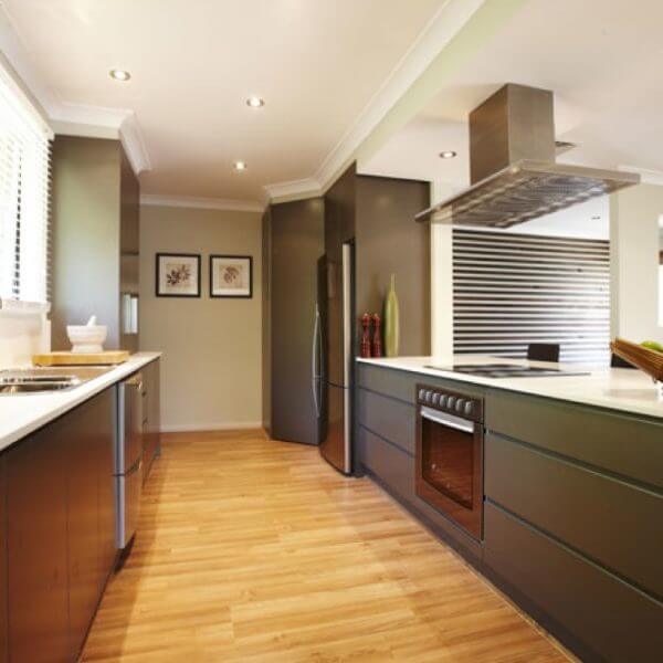 Modern kitchen with wood floors and stove.