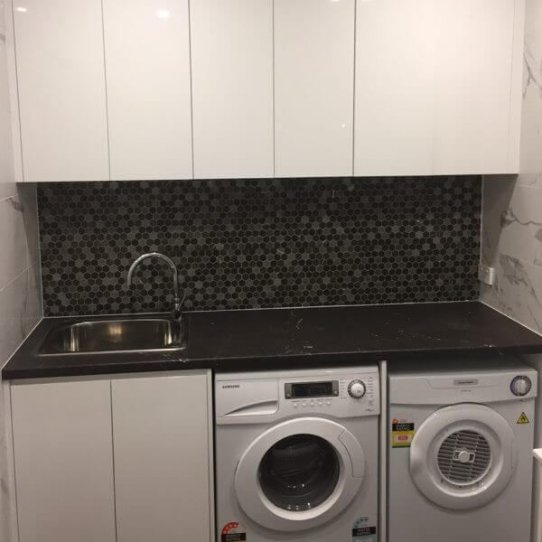 Black and white small modern laundry room