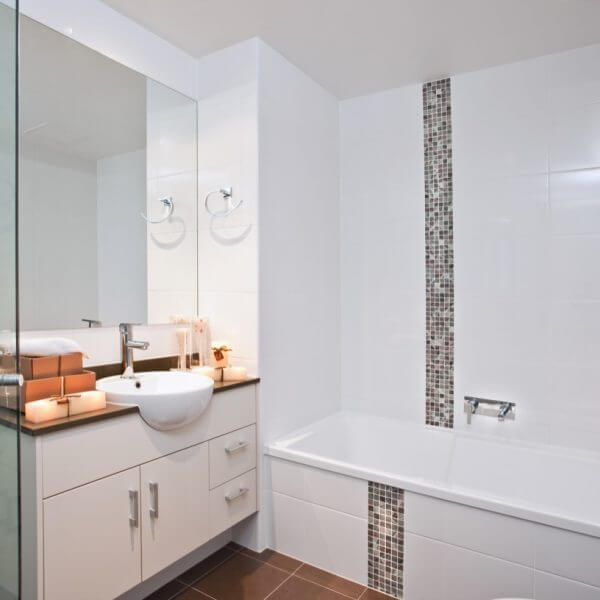White tiled modern bathroom with mosaic tiles,terracotta floor tiles