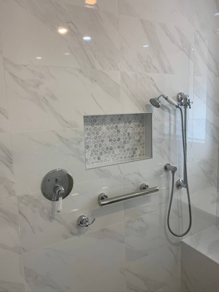 Modern bathroom design showcasing a shower area with hand held shower head.